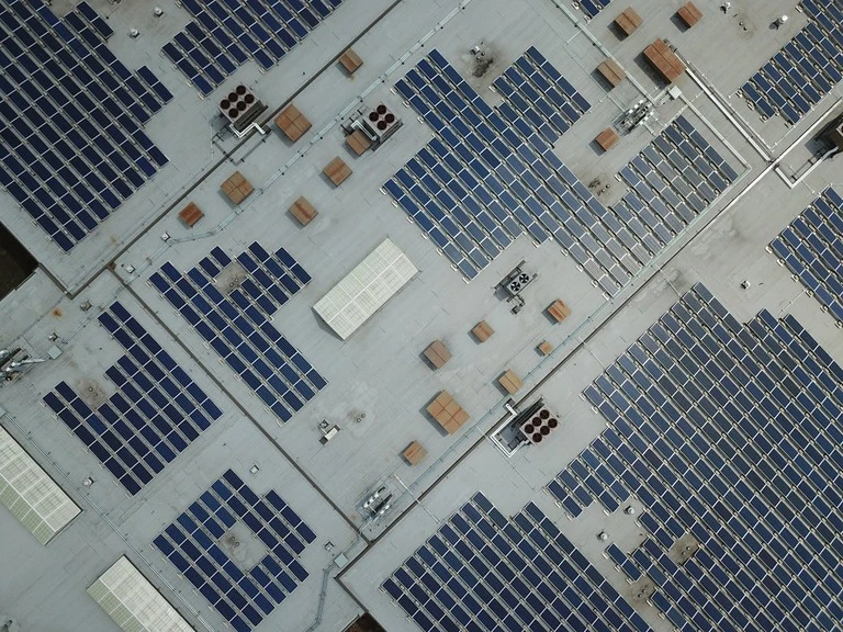 Solar cells installed on a building roof, harnessing sunlight for renewable energy