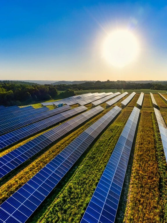 Solar cells on a farm generating solar energy under bright, sunny skies